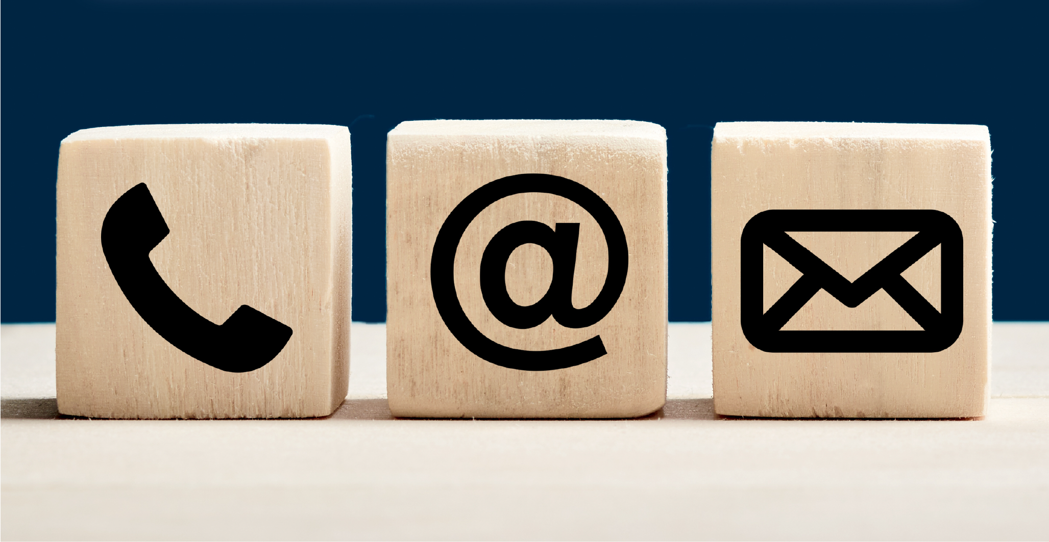 Image of phone and email icons on wooden cubes
